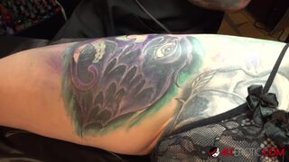 Marie Bossette touches herself while being tattooed