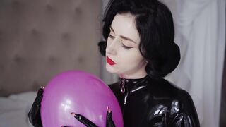 Play with balloons in a latex catsuit