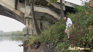 Raven Haired Girl Pees Near The River