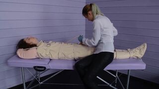 Figging with ginger and Foley bladder catheterization into bondage body bag. Medical play.