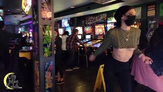 Brazenly flashing boobs in a busy arcade