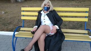 Slut walking in the park in a raincoat and black fishnet stockings with a white elastic band