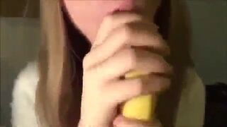 Cute Girl Sucking a Banana with Condom
