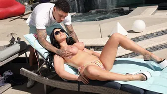 Guy rubs oil on a milfs big tits outdoor