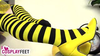 Cosplayer lility is dressed as a bee today, with black and yellow striped stockings, yellow high heels and a tiny costume. She takes off her heels, then her stockings, and starts playing with feet and legs, showing off her flexible skills