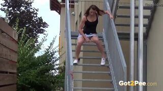 Fit Brunette Pees Down The Stairs