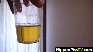 Delightful Japanese chick sits on the latrine and pees in a cup