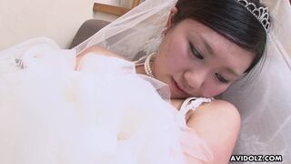Japanese brunette Emi Koizumi in her wedding dress blows her new husband's cock uncensored.