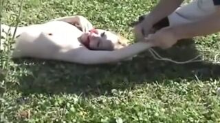 My blonde slut lying tied up on the lawn