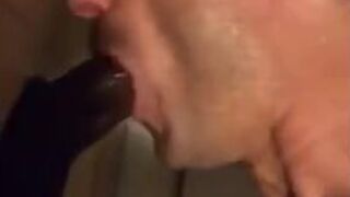 Amateur sucks big black cock at glory hole