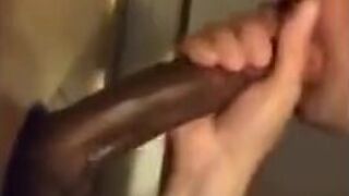 Amateur sucks big black cock at glory hole