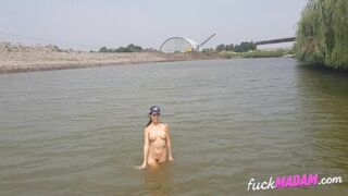 Naked girl masturbates on the river shore