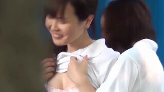 Young Japanese babes touching each others pussy in public