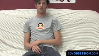 On a couch by himself cute gay man Danny jerks off his dick