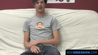 On a couch by himself cute gay man Danny jerks off his dick