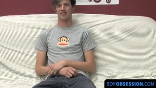 On a couch by himself cute gay man Danny jerks off his dick