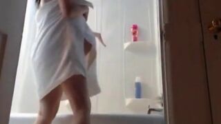 Pregnant woman with big nipples showers at home