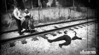 Silent movie star in peril Christie Stevens jerks cock on railroad tracks