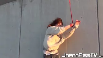 These restrained Asian babes are pissing down their pant legs