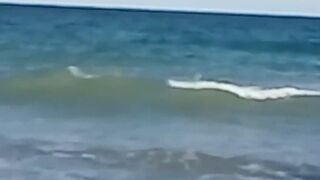 My stepdaughter teases me on the beach