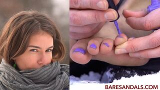 Teresa applies nail polish to her toes outside in the snow - 12400