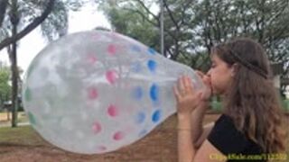 Katie Blows to Pop a Sprayed 18" Qualatex