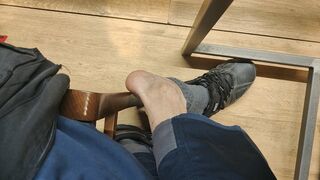 Taking off my socks and shoeplay, sitting at the table in the mall