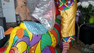 clown girl sit on rhino and blow myllar balloons