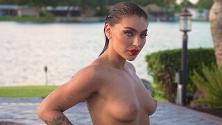 Glamorous naked babe posing by the pool