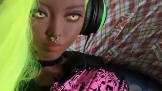 Ebony skinned sex doll masturbates with a joypad