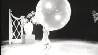 Vintage babe on stage with props doing strip routine