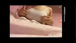 Girl plays with her breasts